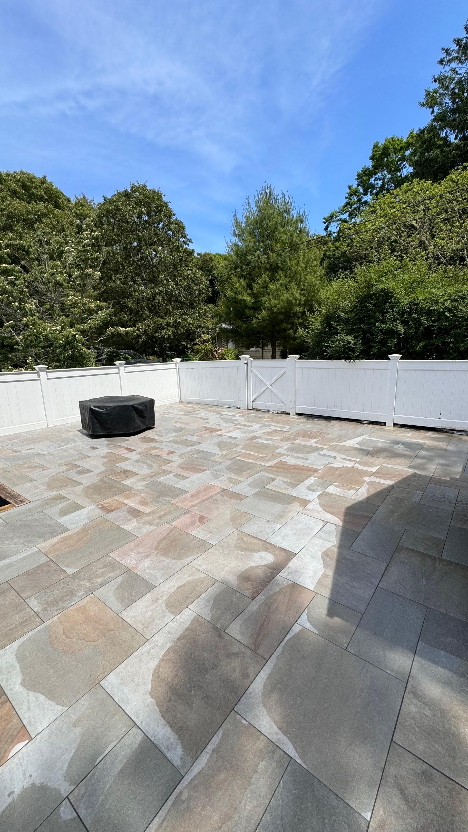 White vinyl privacy fence installation with fresh landscaping