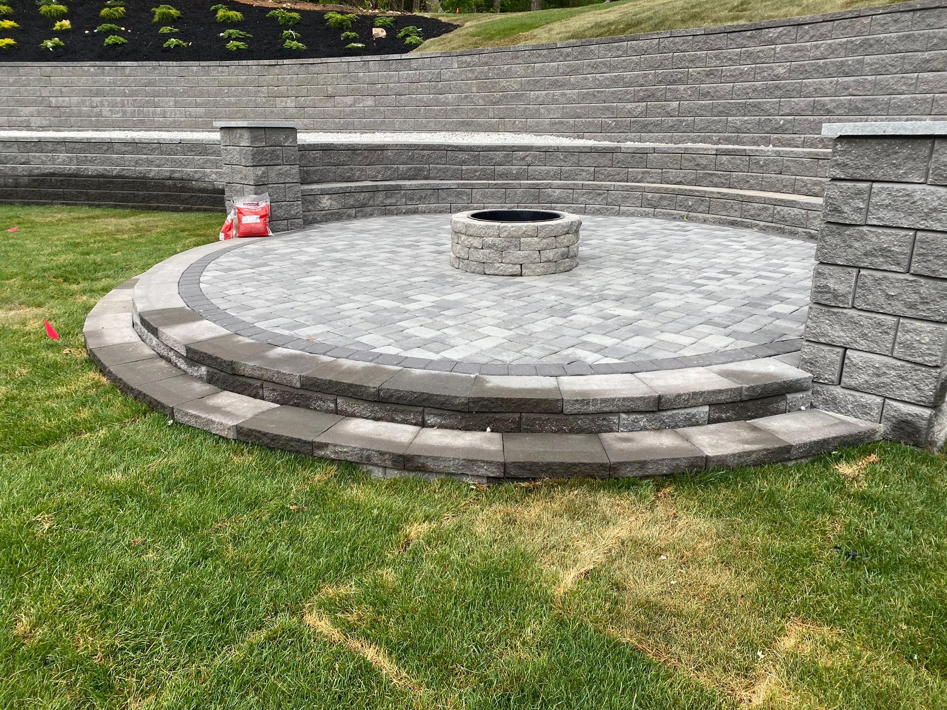 Natural stone patio with curved retaining wall